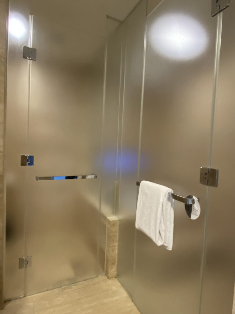 The frosted glass shower booth door
