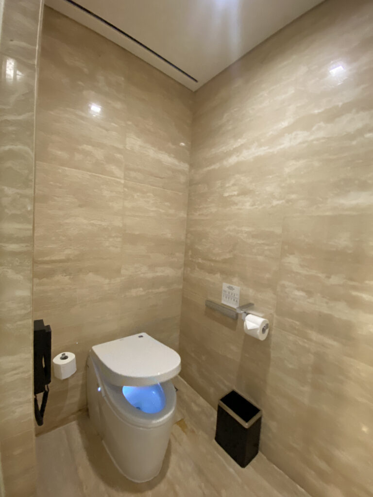 The bidet toilet. It glows with a blue light