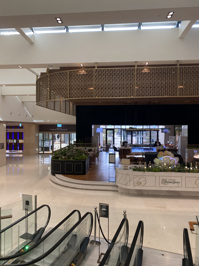 The other side of the lobby. Escalators, a boutique, and floral arrangements on the first floor