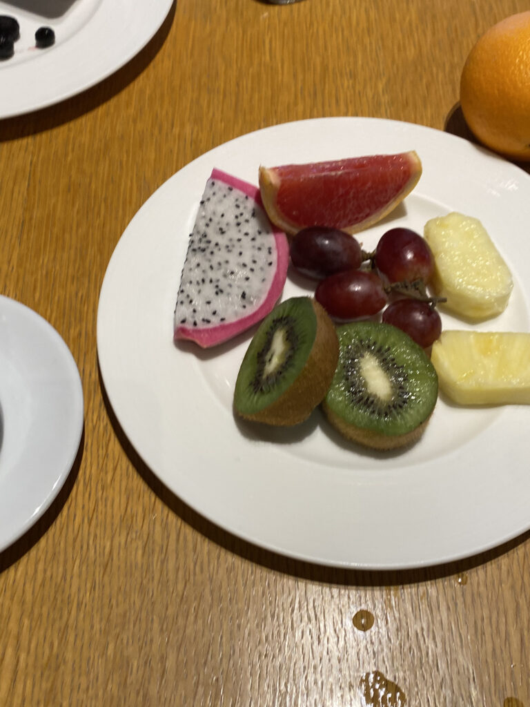 Fruit plate. Dragon fruit, grapefruit, grapes, kiwi, pineapple