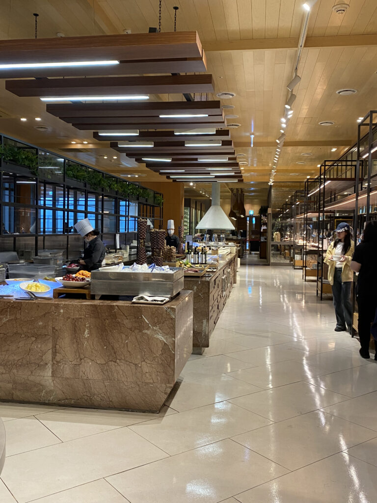 The buffet line. Marble counter, chef, and a long fruit corner