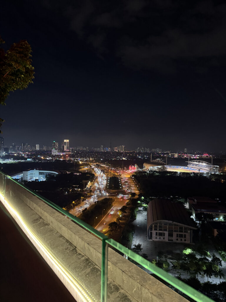 The highway side at night. Car lights stretching in long lines