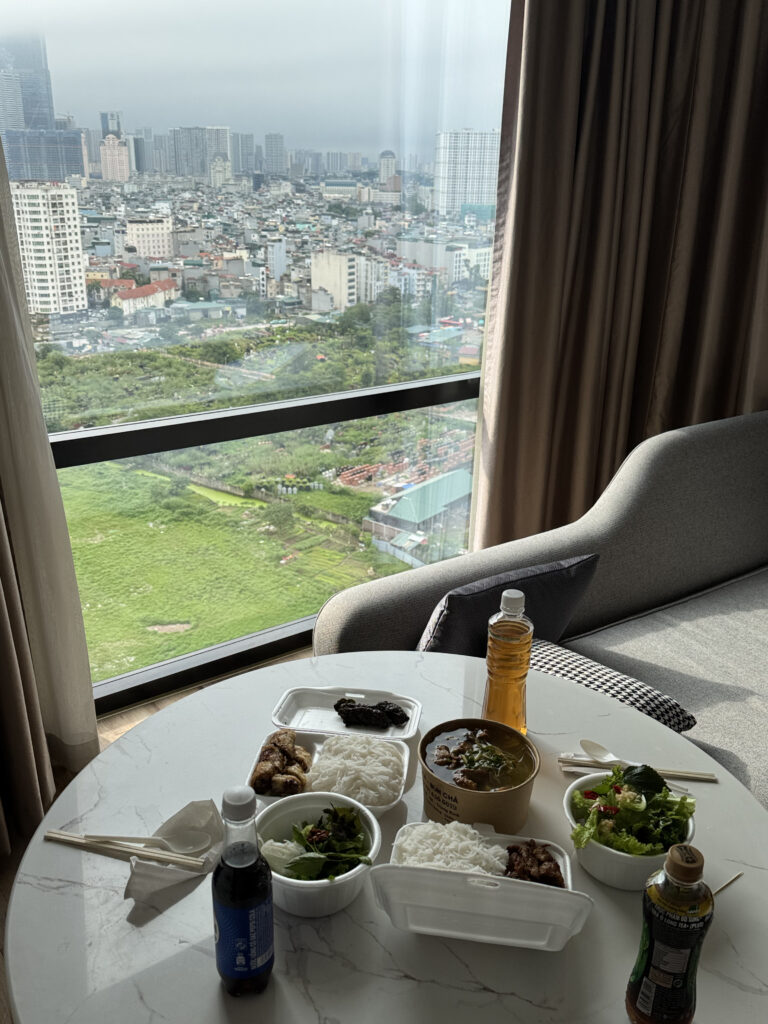 The bun cha set delivered by Grab. Lunch spread out on the window table on a rainy day